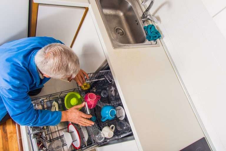 man cleaning dishwasher