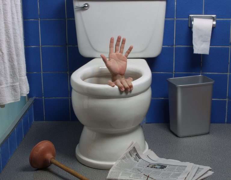 hand sticking out of toilet, clogged