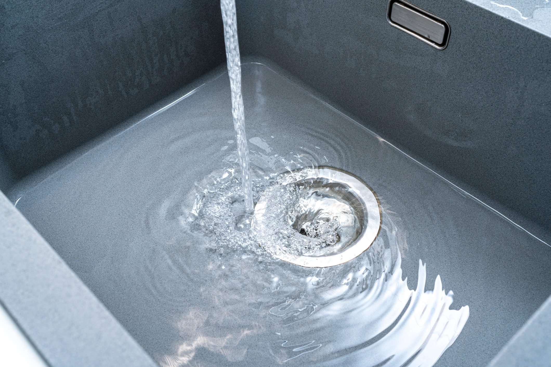 an overflowing slow sink drain in bathroom