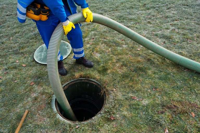 Emptying household septic tank. Cleaning sludge from septic system.