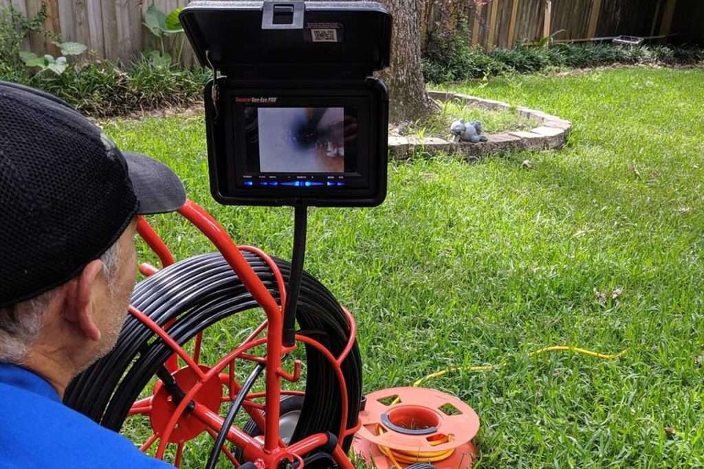 plumber conducting a sewer video camera inspection