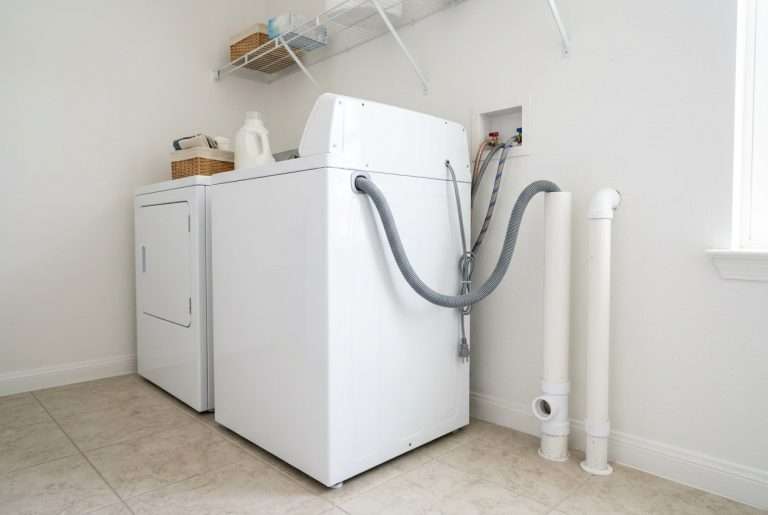Washing machine drain hose connected to standpipe in laundry room
