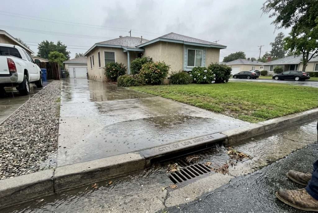 Rainwater pooling near a storm drain during a Southern California storm