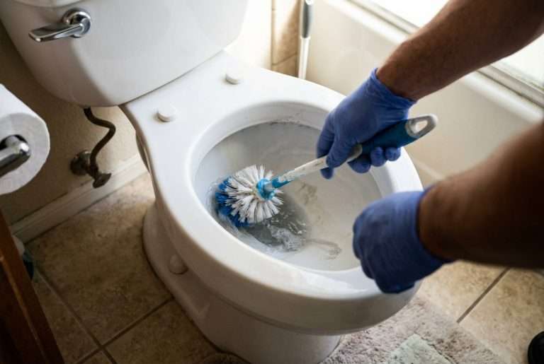 Cleaning a residential toilet bowl with a toilet brush